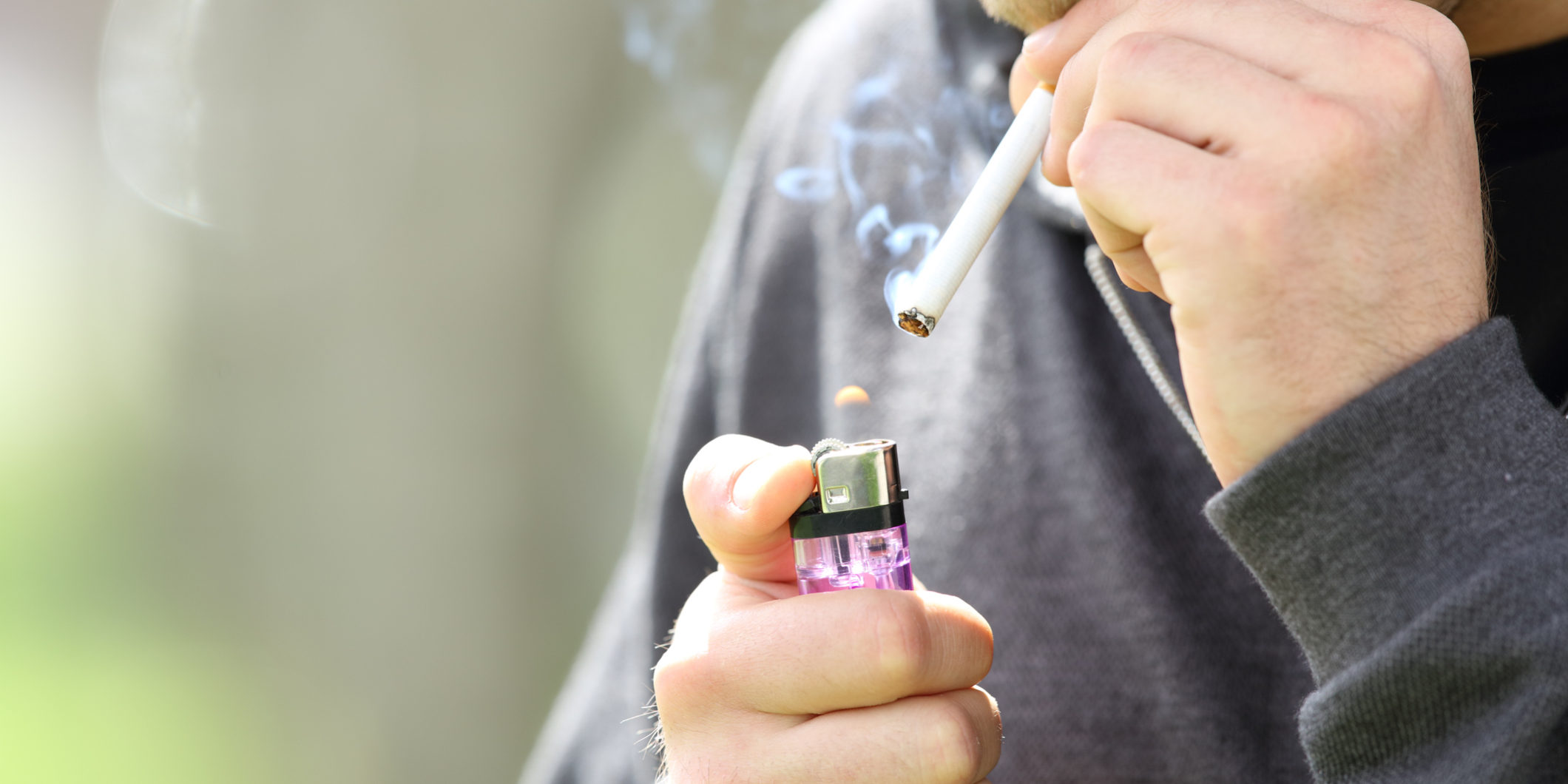 Teen hands lighting a cigarette to smoke