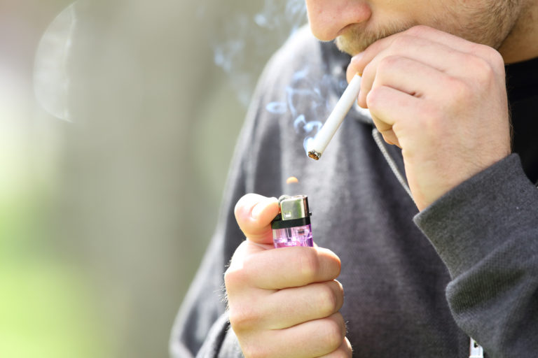 Teen hands lighting a cigarette to smoke